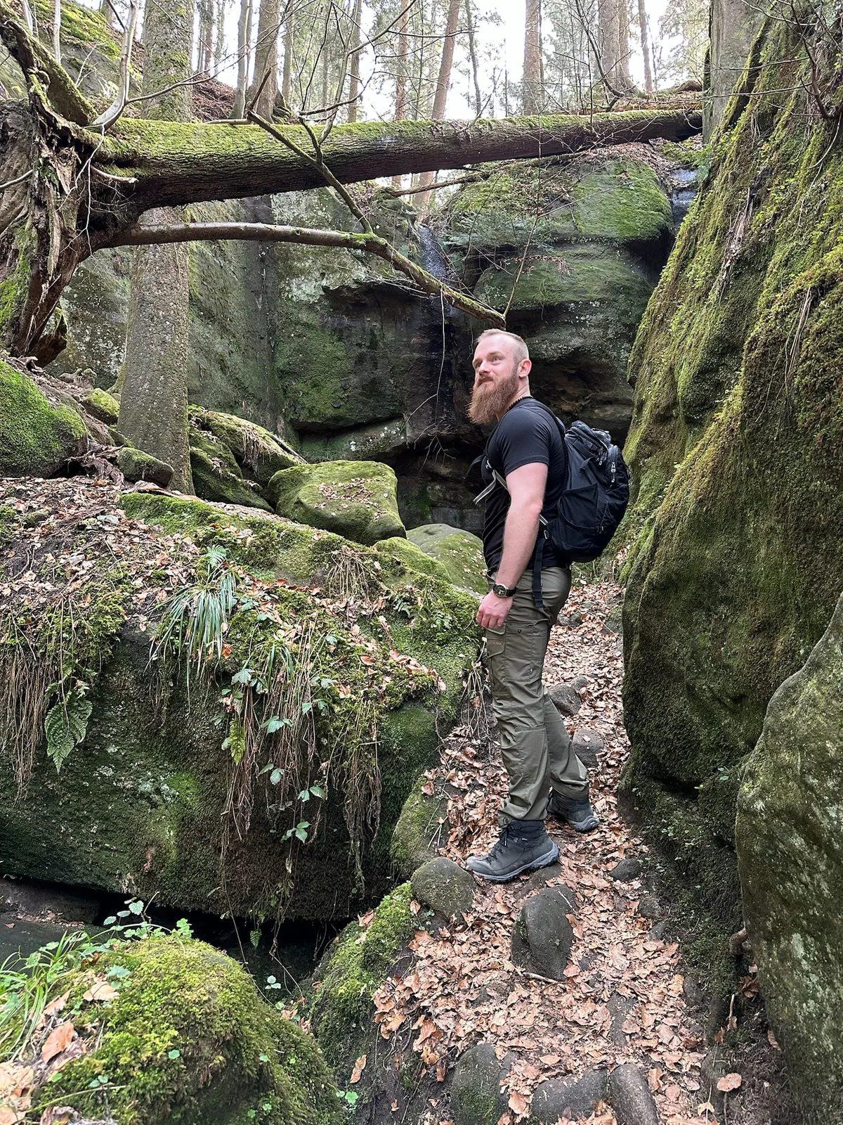 Daniel Hauck outdoors, in a landscape of low hills under an open sky.